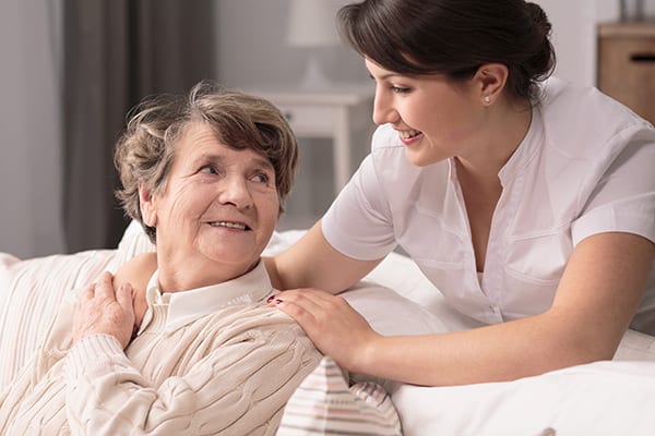 nurse assisting a senior woman